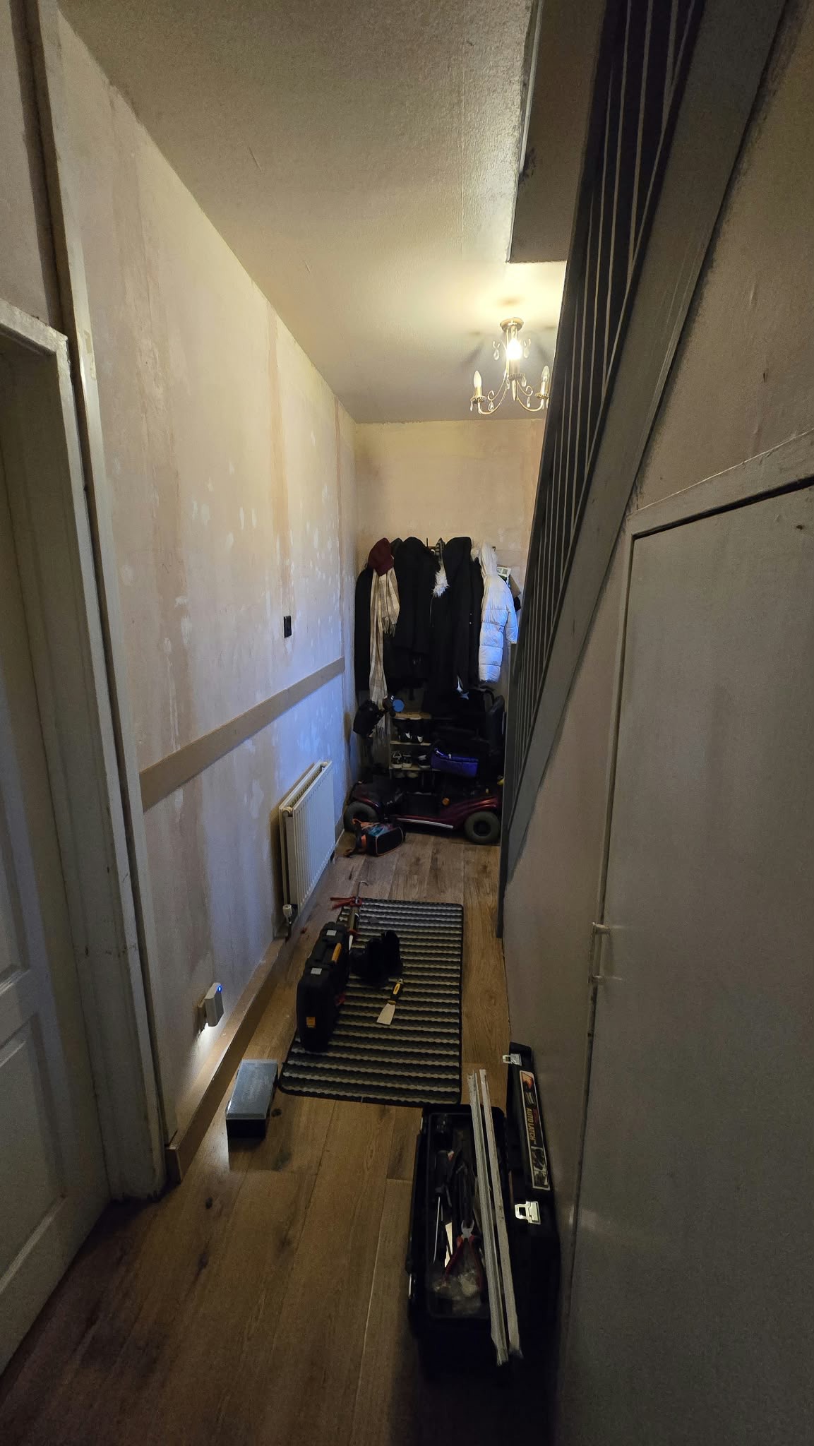 My hallway after stripping all of the old wallpaper, filling and repairing the cracks and holes, and the very start of adding panelling to the lower half of the wall